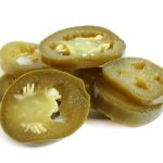 Slices of preserved Jalapeno pepper on a white background